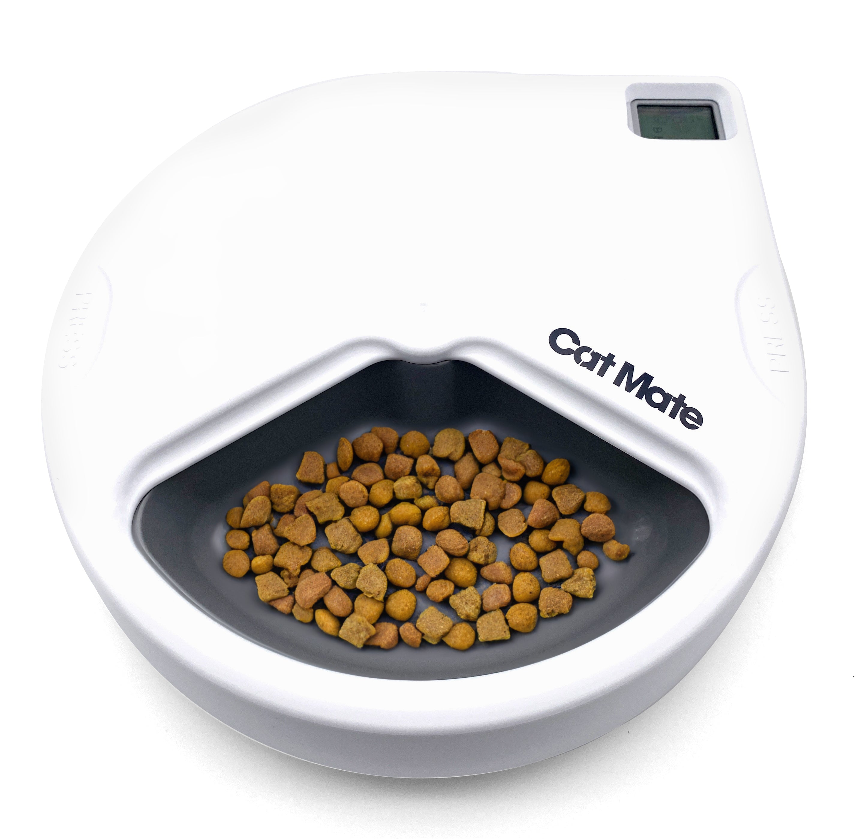 The image shows a Cat Mate automatic pet feeder with digital timer, filled with dry cat food. The feeder is white with a gray bowl and black accents.