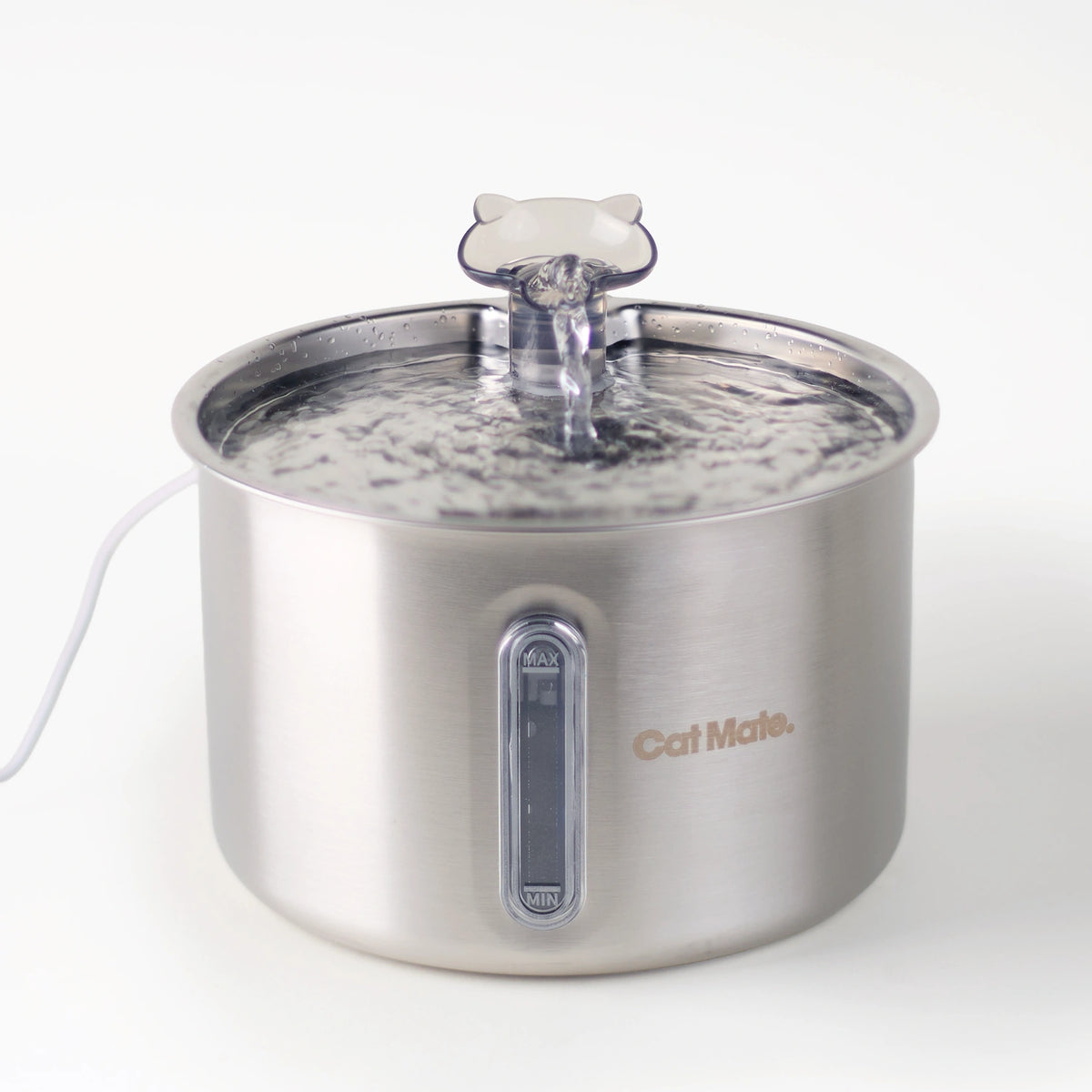 A front-on view of the corded Cat Mate stainless steel pet water fountain with a cat-shaped spout, shown with water flowing from the top in to the 2.2L capacity reservoir, on a clean white background.