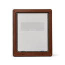 A brown pet door frame with a large clear flap which is suitable to be used by larger dogs such as German shepherds and Labradors, and has a two way locking mechanism and a matching brown security panel, on a white background