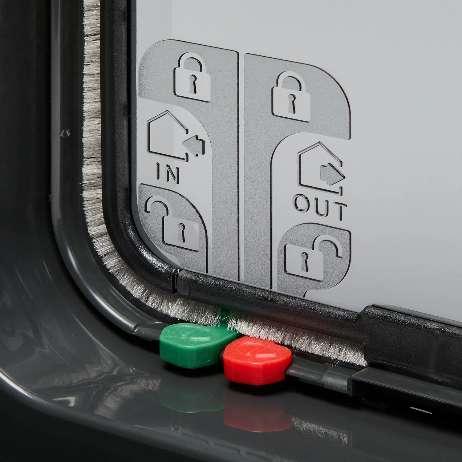 A close up view of one of the sides and locks of the grey cat flap