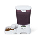 Pet food dispenser with dry pet food in the bowl, and a digital display on a white background