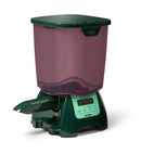 Green and purple pet food dispenser suitable for pond fish such as koi and goldfish on a white background