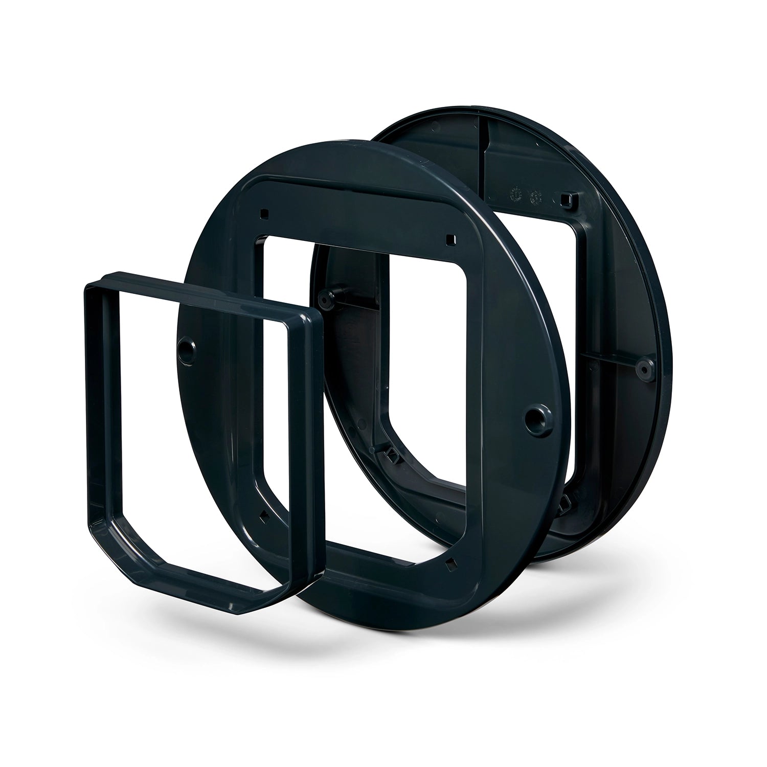 The three dark grey pieces of the cat flap adapter which allows the cat flap to be installed in to glass