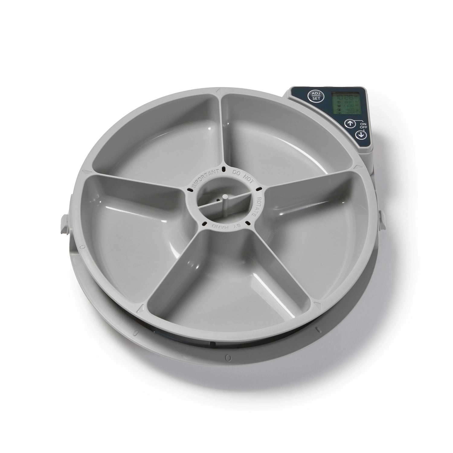 Top view of Cat Mate automatic pet feeder showing circular tray divided into five grey compartments with central rotating mechanism and digital control panel positioned at top right corner