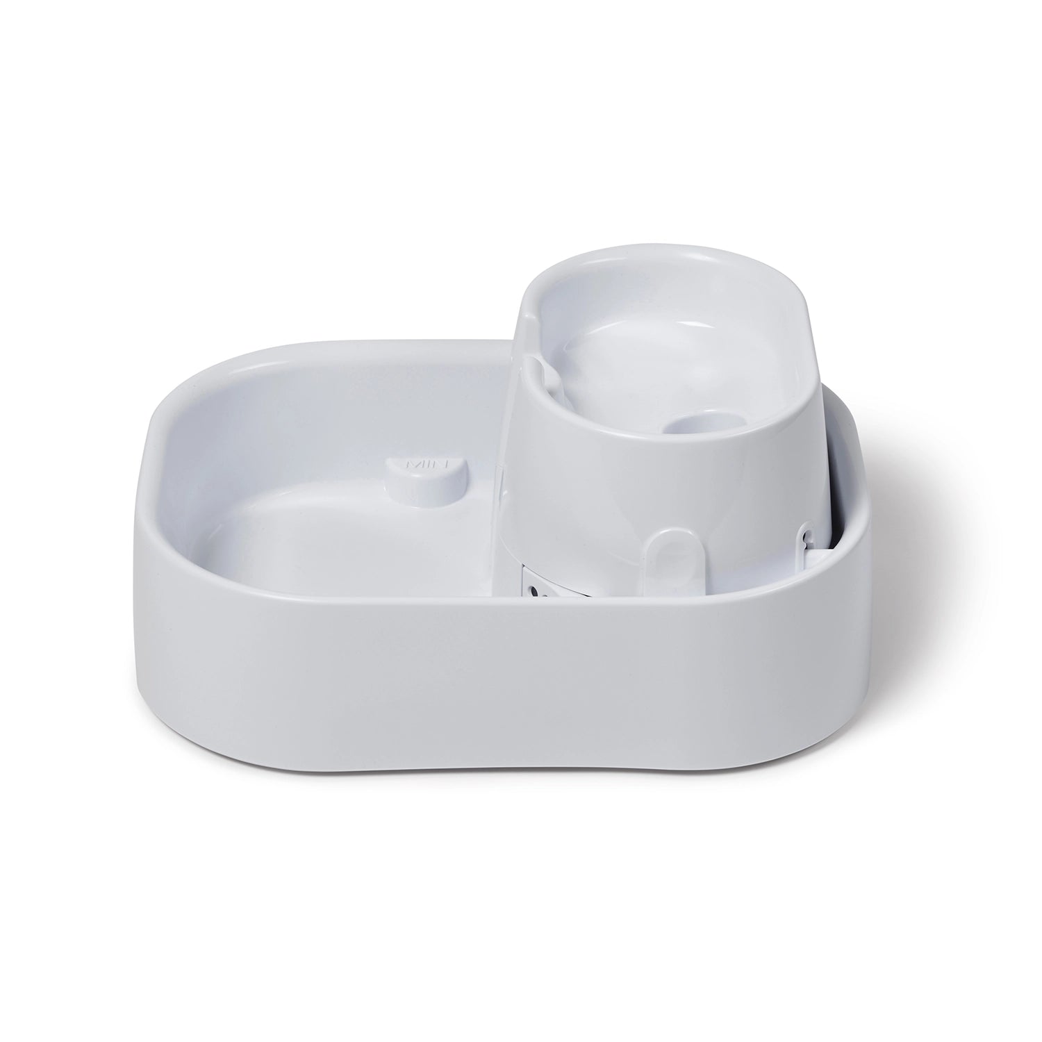 A side on view of an empty white pet water fountain on a white background