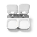 White and grey empty pet bowls in the two meal automatic pet feeder with open lids on a white background