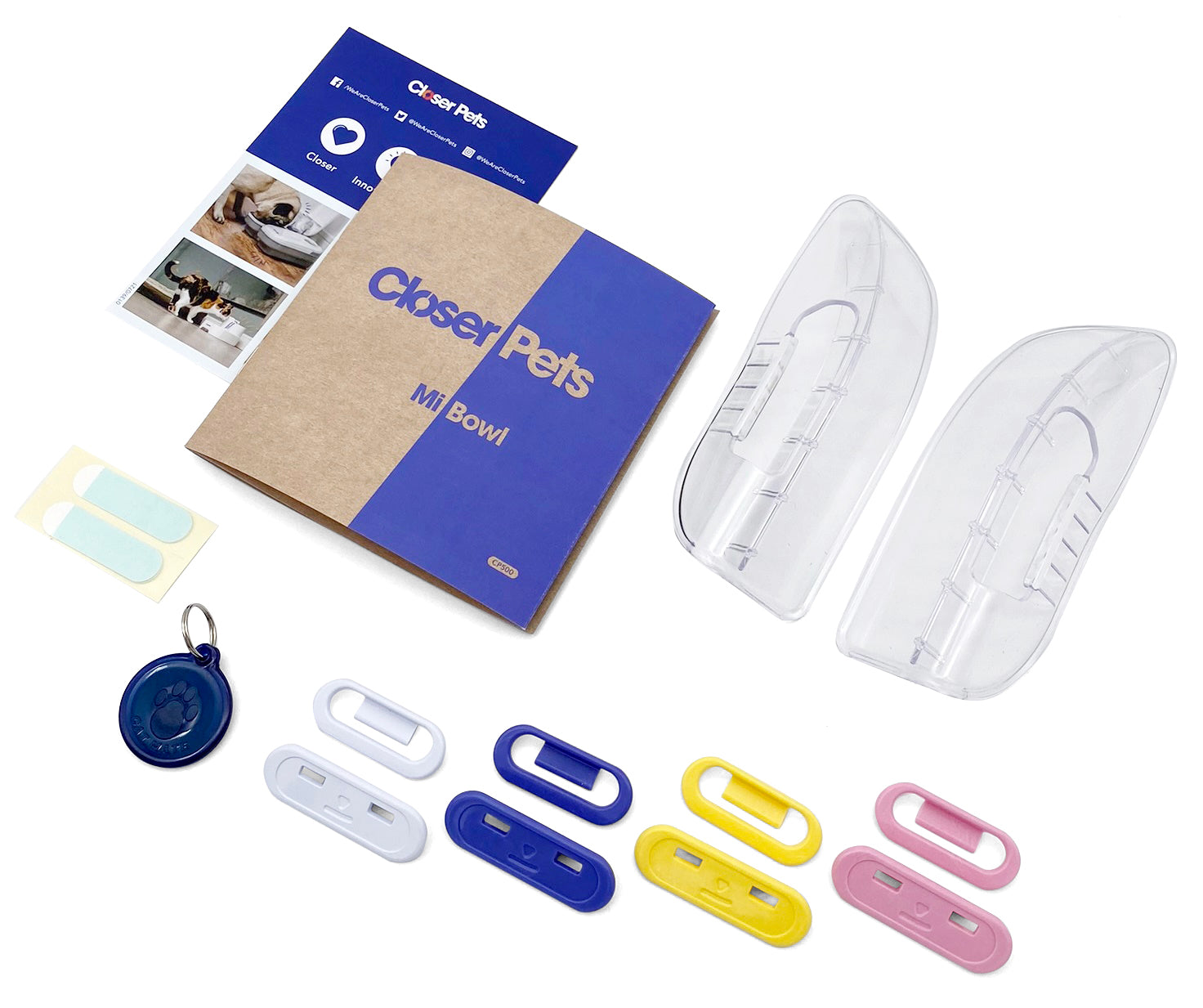The instruction manual and accessories for the MiBowl, including different coloured clips on a white background