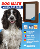 Packaging for DOG MATE Medium Dog Door featuring a photo of a black and white spaniel-type dog on the left and the brown dog door on the right. The product highlights include a 2-way locking security panel, suitability for cats and dogs up to 460mm (18") shoulder height, and a 3-year guarantee. Product descriptions are provided in German, French, Spanish, and Dutch.
