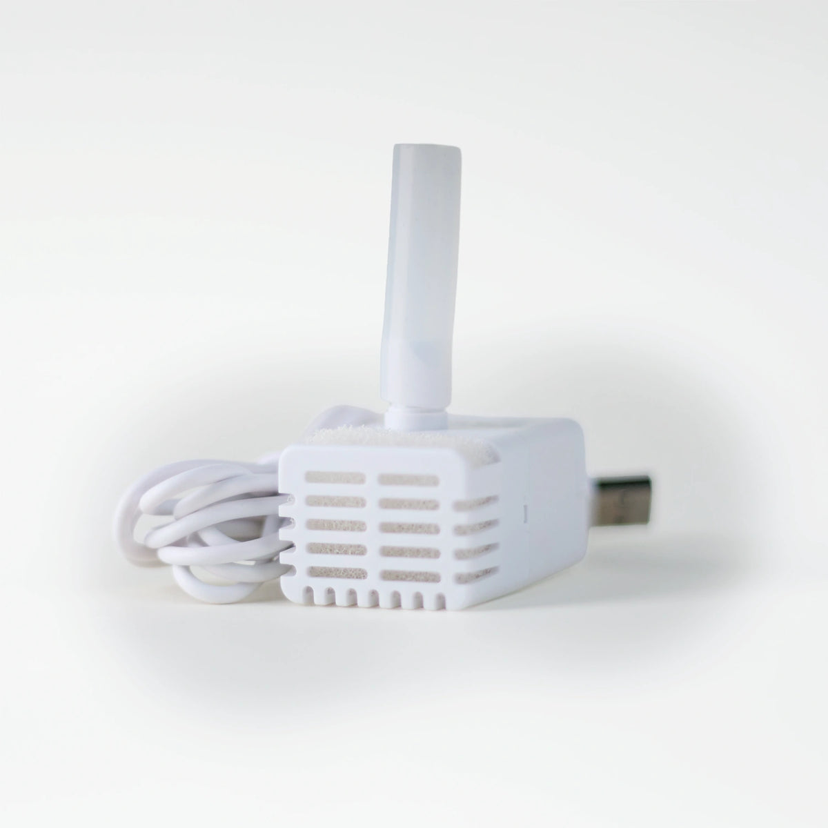A close-up product shot of the pump, filter and USB power cord for the Cat Mate corded stainless steel fountain on a white background