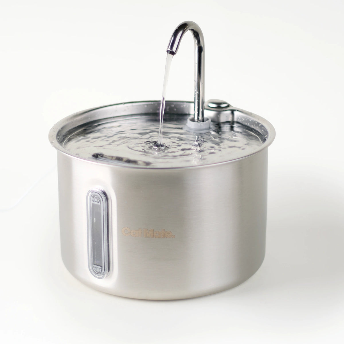 A side angled view of the stainless steel Cat Mate pet water fountain with a curved faucet and water flowing into the bowl, shown on a clean white background.