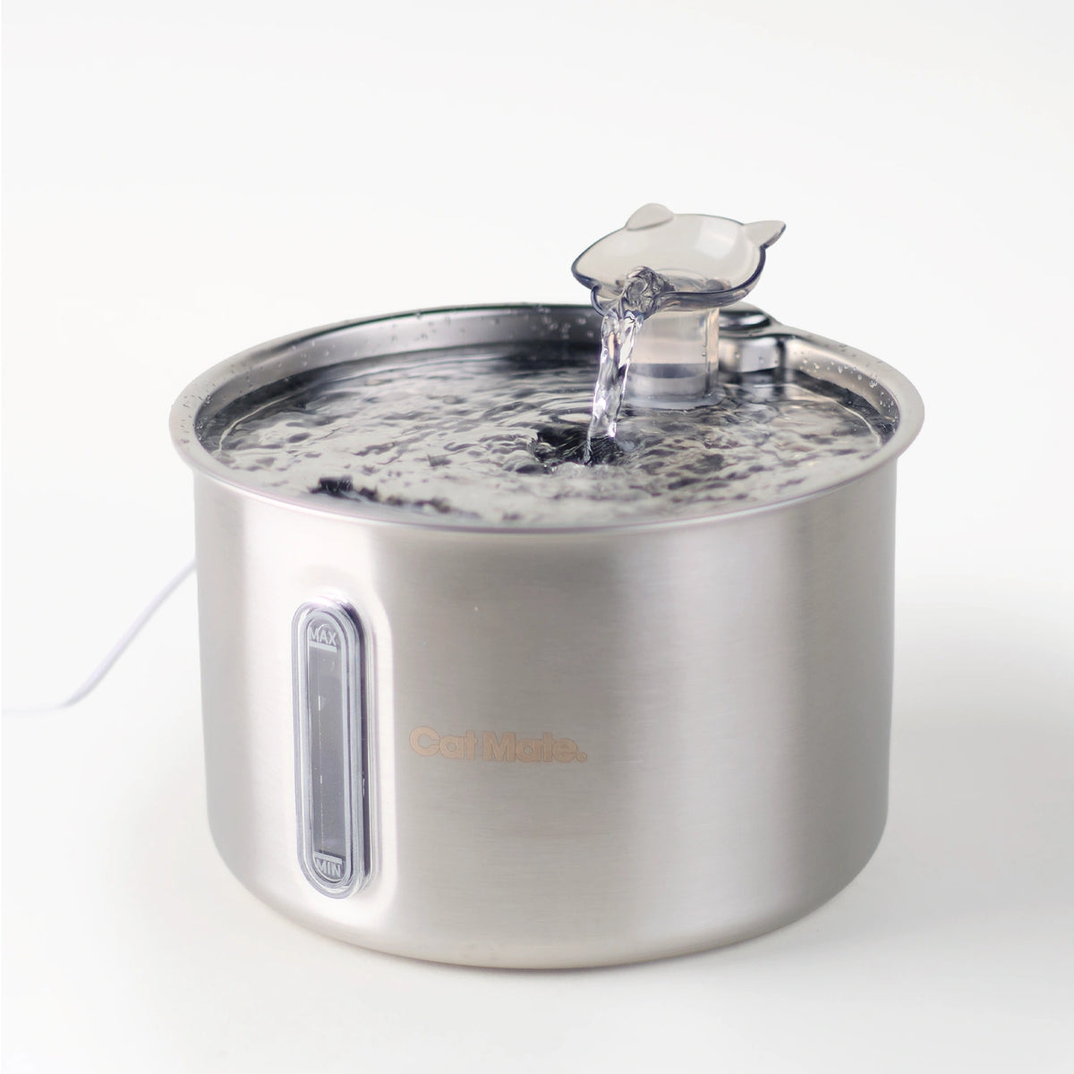 A side angled view of the stainless steel pet water fountain made by Cat Mate with an interchangeable cat-shaped spout pouring water in to the bowl below, shown on a clean white background.