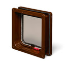 A side on view of a brown pet door with a clear flap for average size cats which is equipped with a locking mechanism and is self lining up to two inches, on a white background