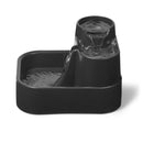 Dark grey pet water fountain with flowing water, suitable for cats and small dogs to drink from, on a white background