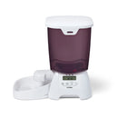 Pet feeder with digital display and an empty white pet bowl on a white background