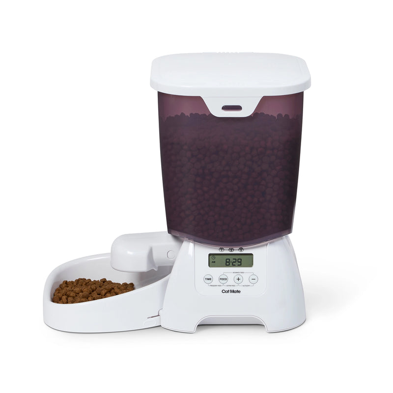 Pet food dispenser with dry pet food in the bowl, and a digital display on a white background