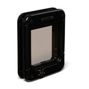 A side angled view of a black rotary cat flap on a white background 