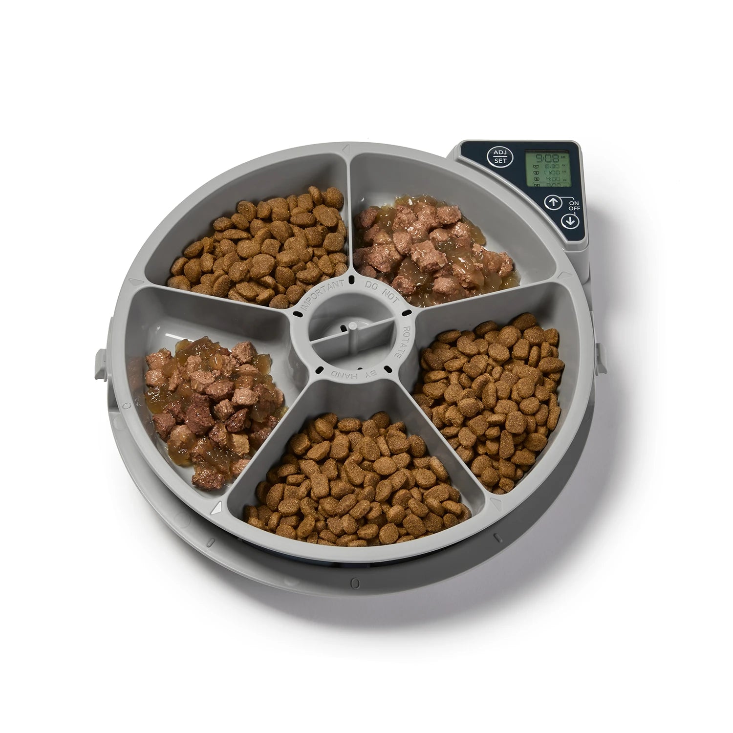 Pet food dispenser with all five  compartments filled with kibble and wet food on a white background