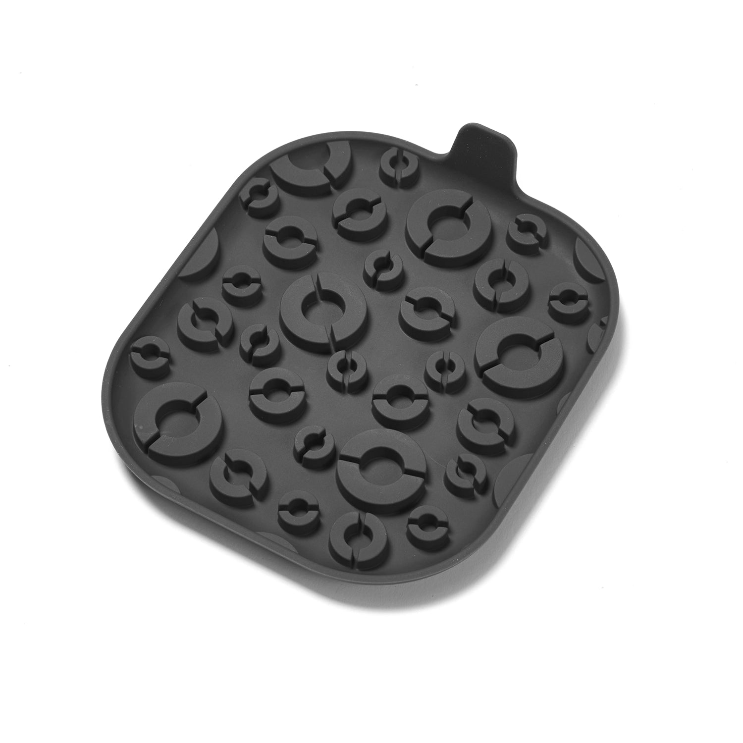 Black silicone lick mat for pets with various shapes on a white background