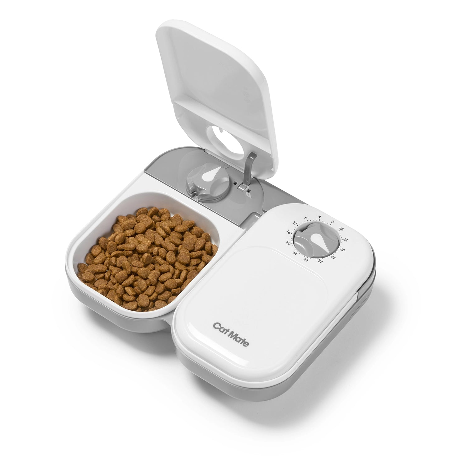 White and grey pet food dispenser with brown kibble in an open bowl adjacent to a closed bowl on a white background