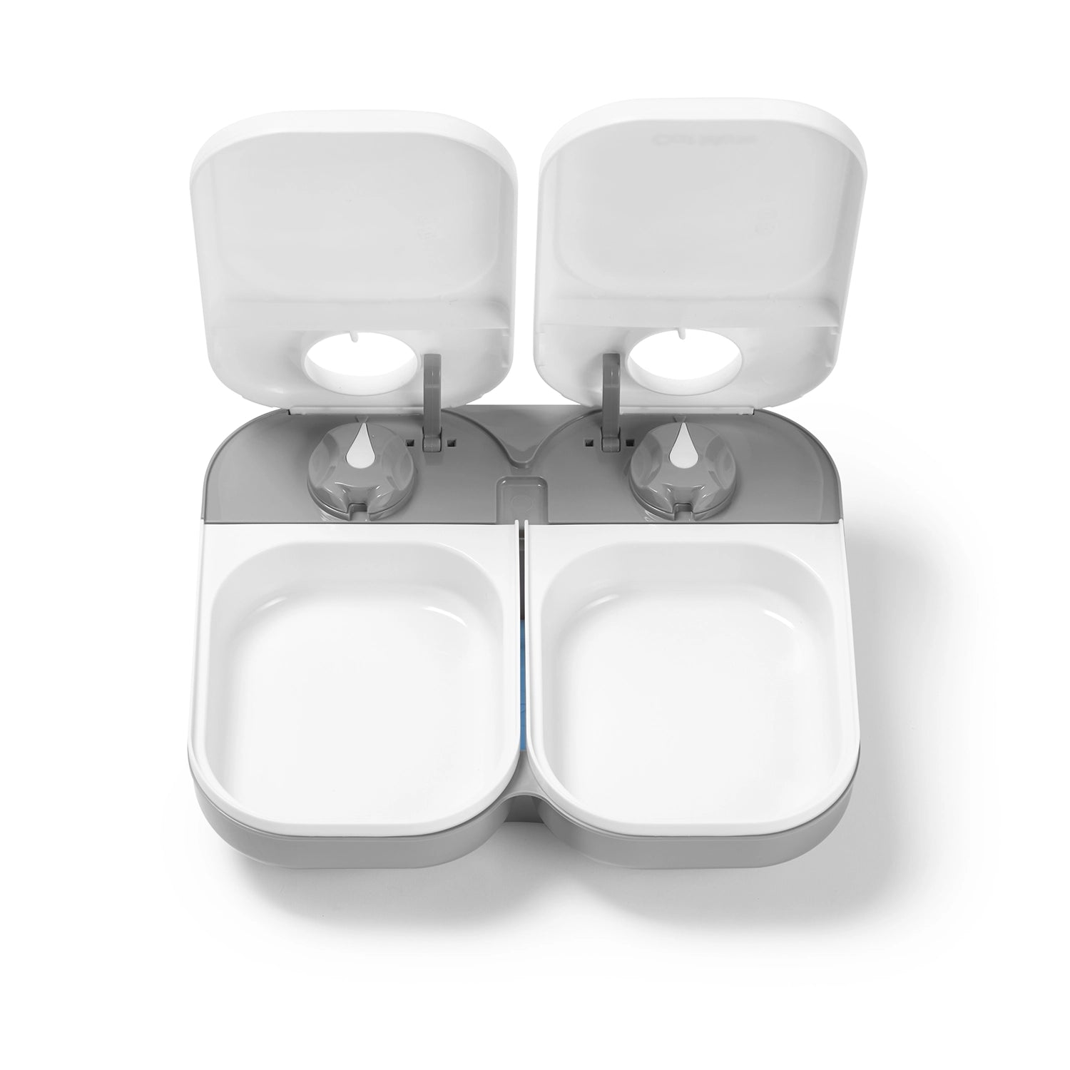 White and grey empty pet bowls in the two meal automatic pet feeder with open lids on a white background