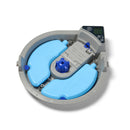 Top-down view of the underside of a circular automatic pet feeder. The feeder features two blue, curved ice packs labelled 'Closer Pets,' positioned to help keep food cool. At the top is a digital control panel with buttons and a screen display. A central battery compartment indicates space for 3 AA batteries, with text reading: 'Replace batteries when required to keep serving!' A blue rotating mechanism is positioned at the centre for tray movement