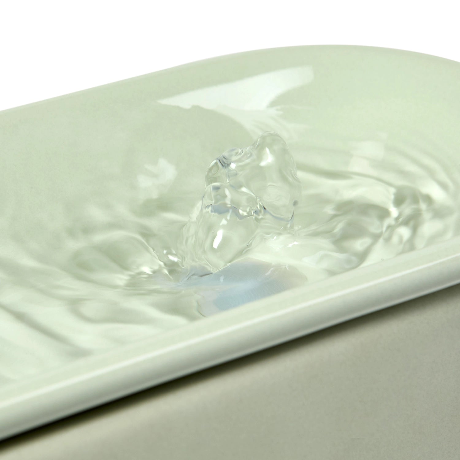 A close-up photo of the sage green Cat Mate 800ml capacity ceramic cat water fountain showing water bubbling around the pump spout, against a white background 