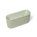 Photo of the Cat Mate sage green ceramic pet water fountain with a sleek, oval-shaped design. The fountain features a glossy finish with a lid that has an indented well where water flows. The minimalist design shows the compact, rectangular shape from an angled top view against a white background.