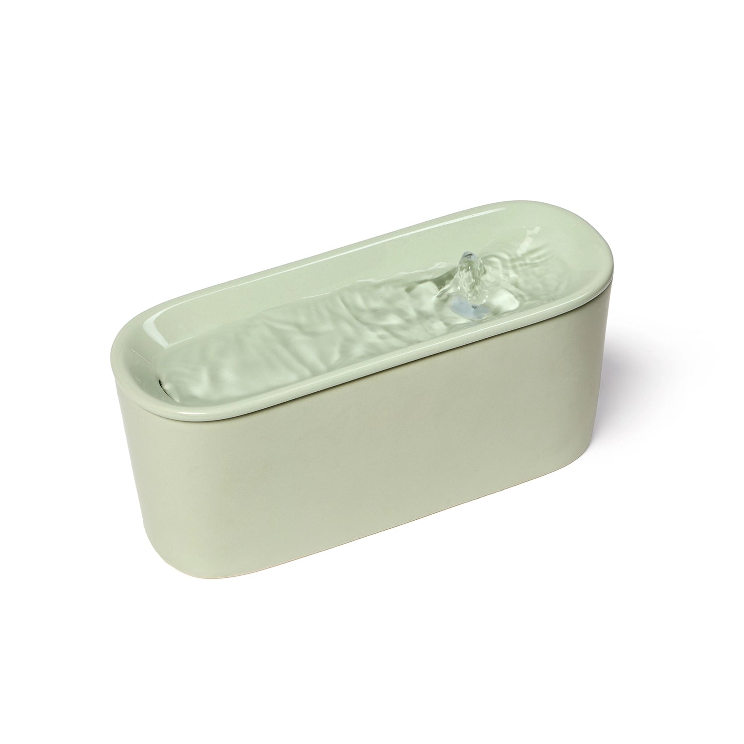 A front image of the Cat Mat ceramic Cat water fountain in sage green, which has an 800ml capacity and is powered by a USB charger, and shows water bubbling and flowing across the top level of the fountain, against a white background. 