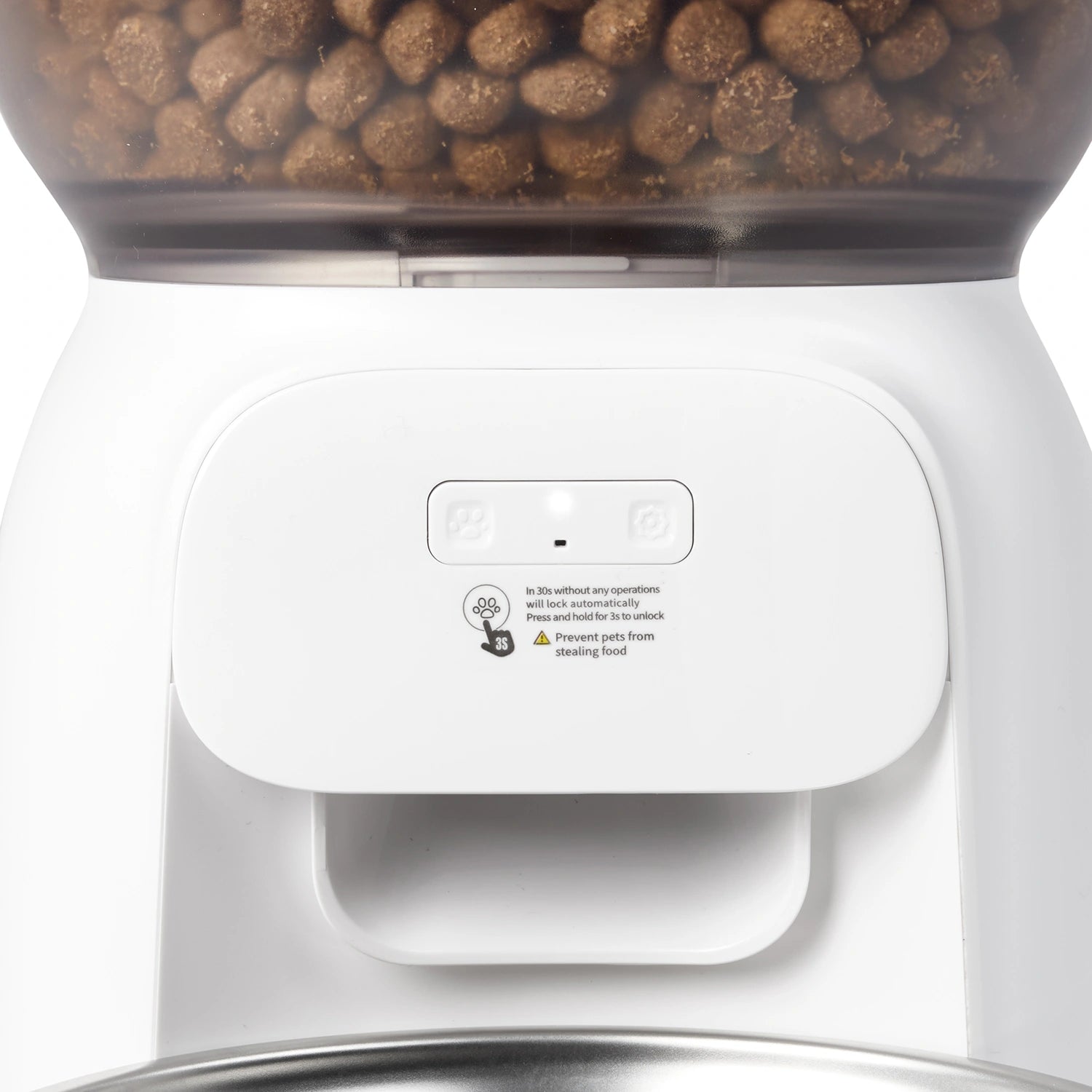 Close-up of a white pet food dispenser made by Cat Mate filled with brown kibble, showing the top container and front control panel with small icons and warning text.