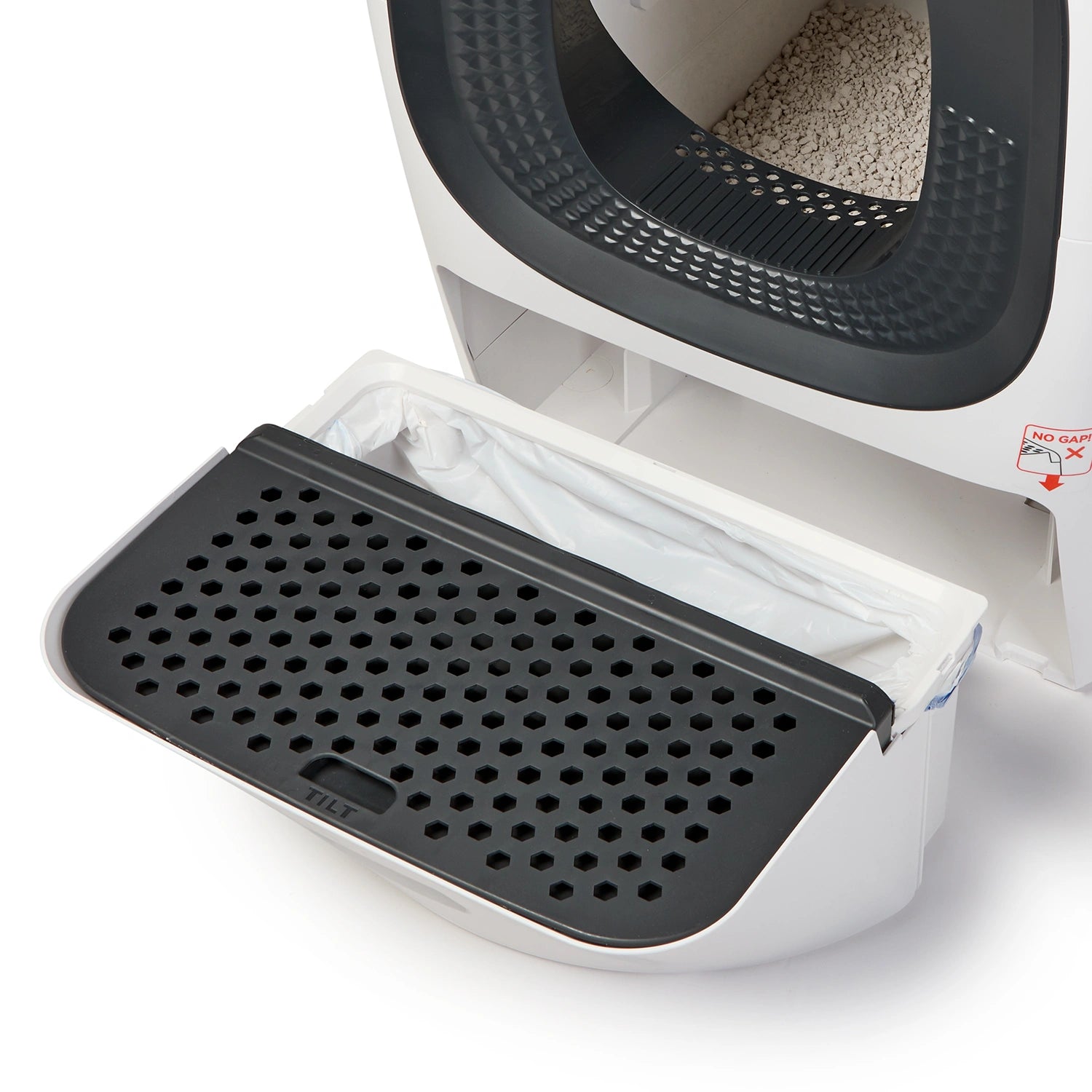 Cat Mate litter box waste drawer with black perforated litter scoop mat positioned on top of white liner bag, showing waste collection system with dark interior cavity above